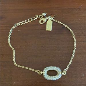 Kate spade gold bracelet with sparkly oval charm.